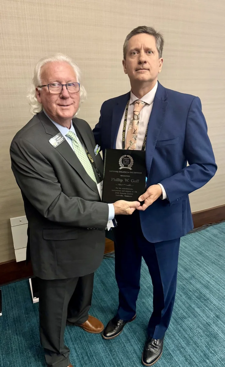 Bruce Edge, NCDD president, presents Phillip Goff with a recognition plaque